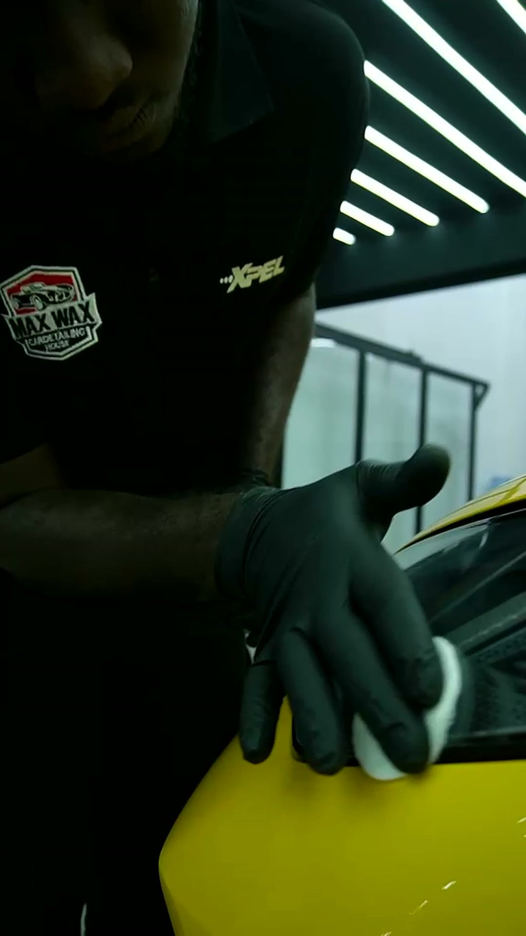MAX WAX technician finishing a repaired panel by hand in the Al Quoz studio